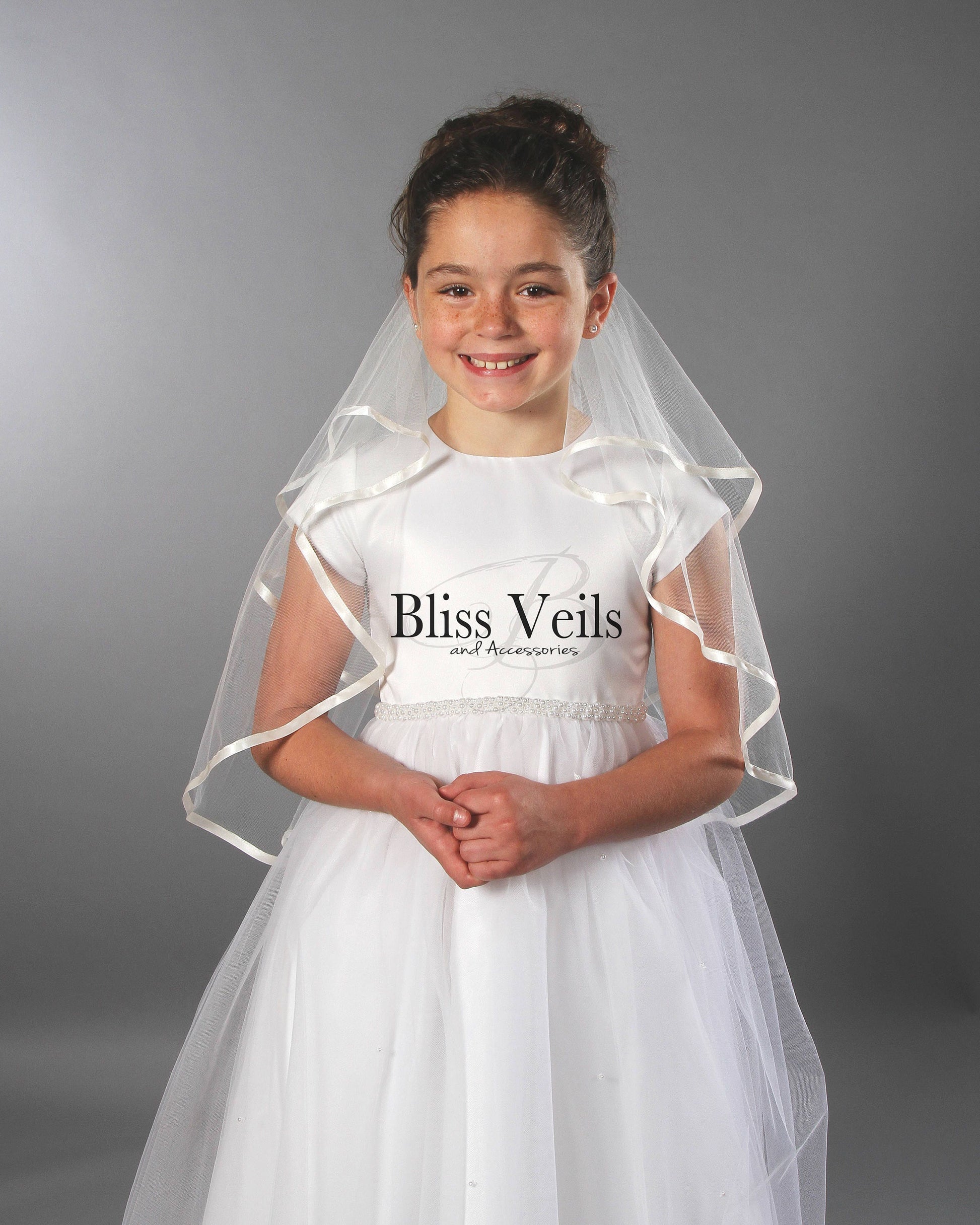 First Communion veil with soft tulle and a delicate ribbon edge