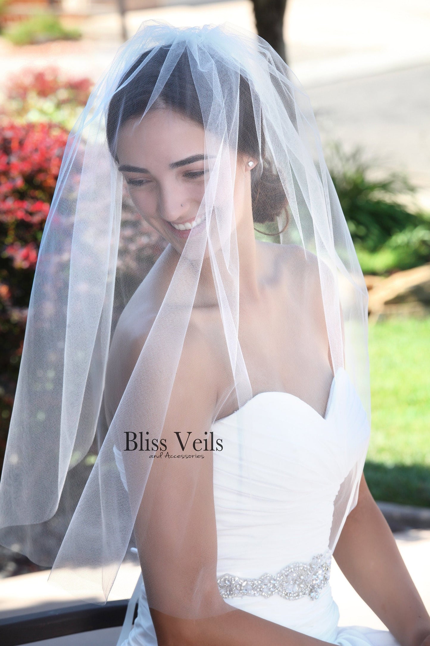 Lightweight raw edge blusher veil add on in sheer tulle shown in bridal styling