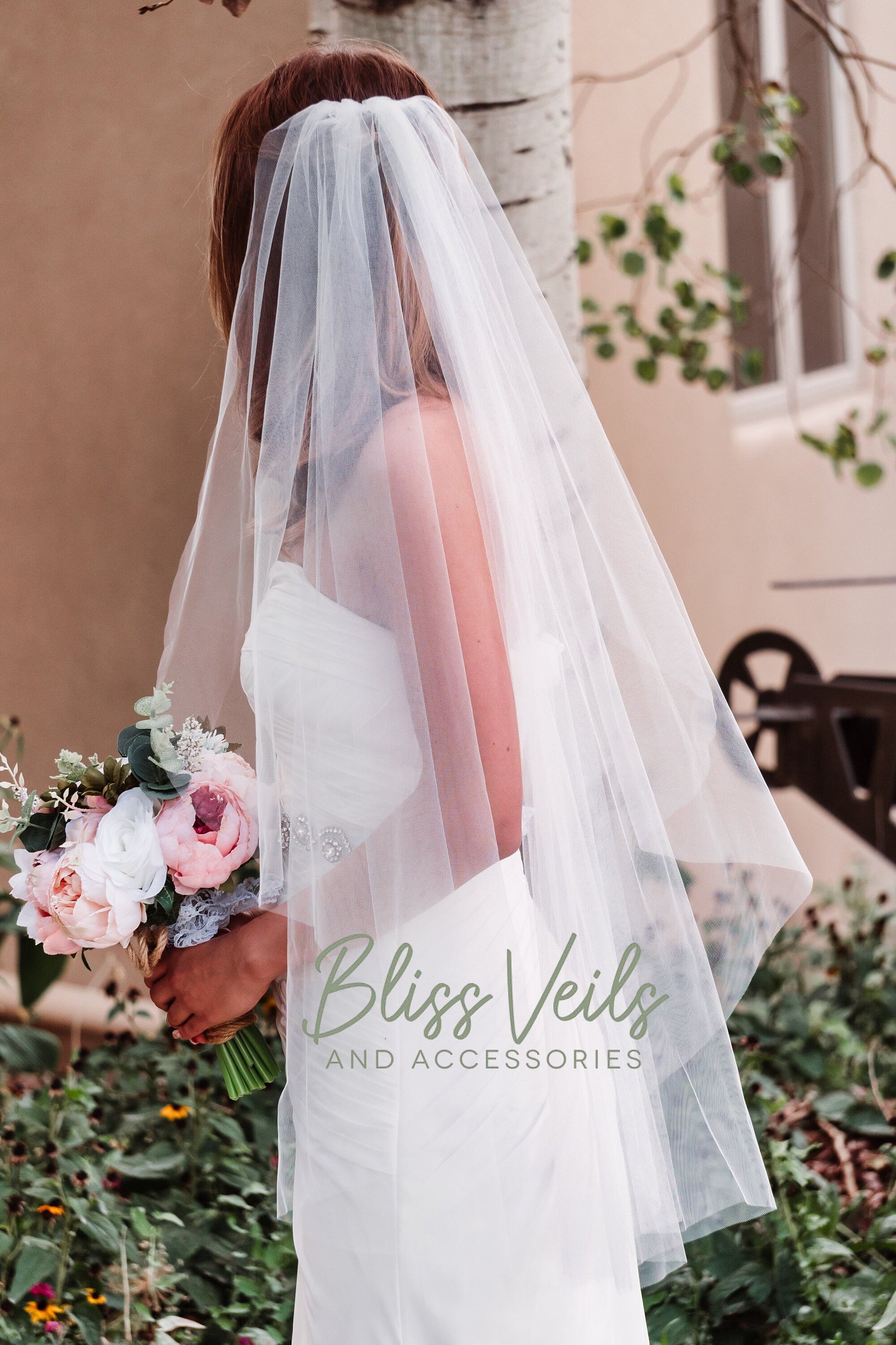 Angel cut raw edge wedding veil in soft tulle shown from a different angle highlighting the flowing shape