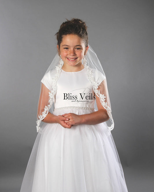 First Holy Communion veil with lace edge in soft white tulle worn for a traditional Catholic ceremony