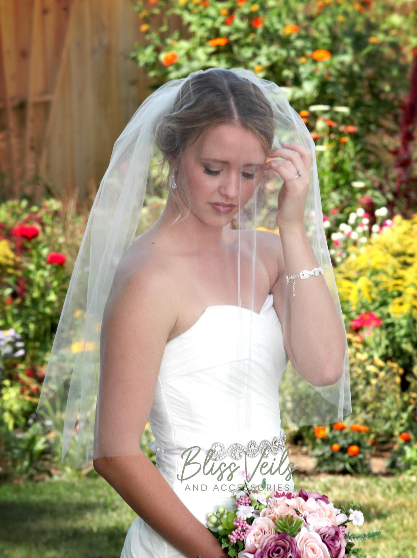Sheer raw edge blusher veil add on in soft tulle with metal comb layered over a wedding veil
