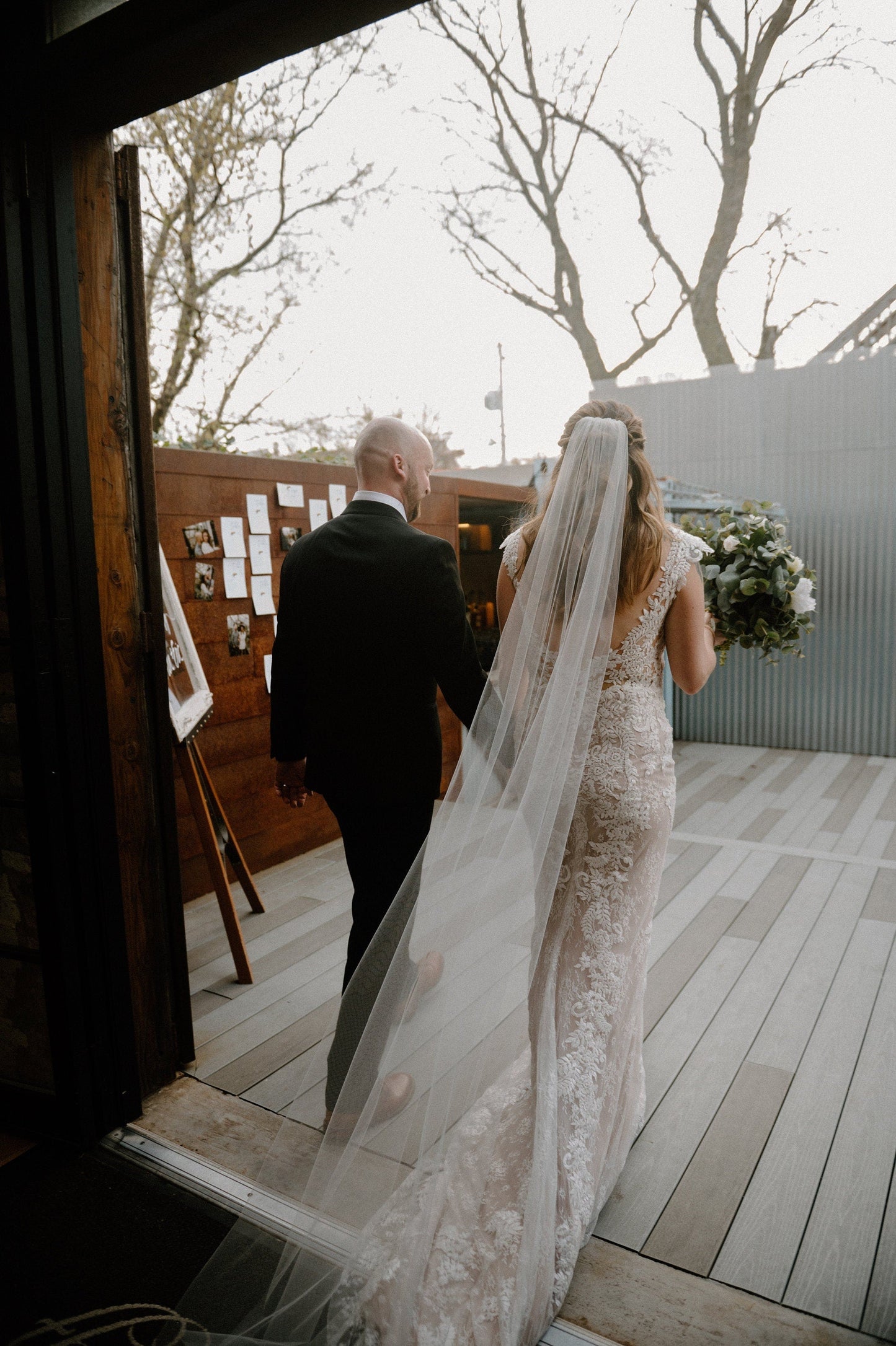 Sheer one tier wedding veil with cut edge made from soft tulle, shown in chapel length with light tapered fullness