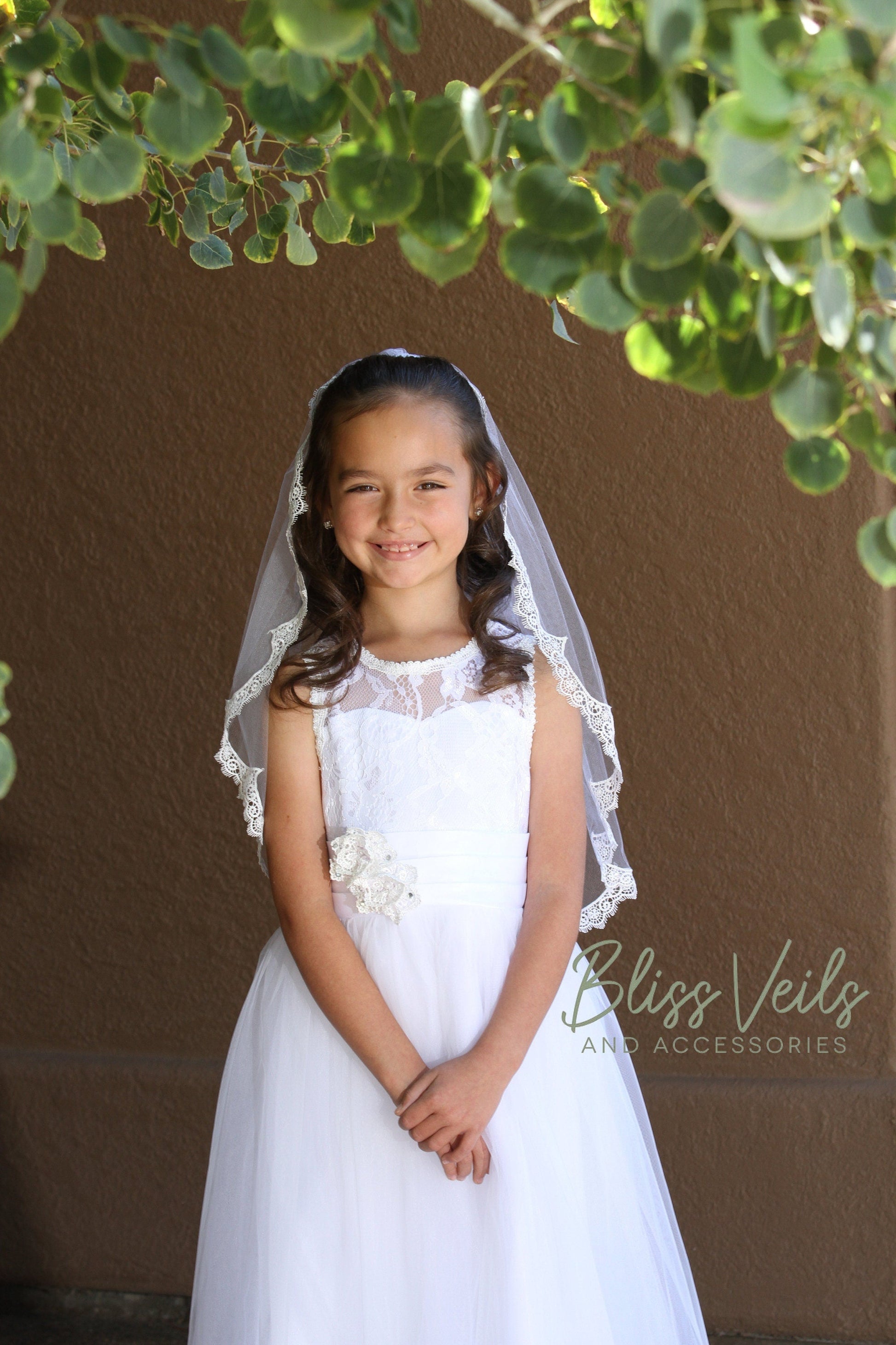 First Communion veil featuring scalloped lace trim and traditional one-layer design