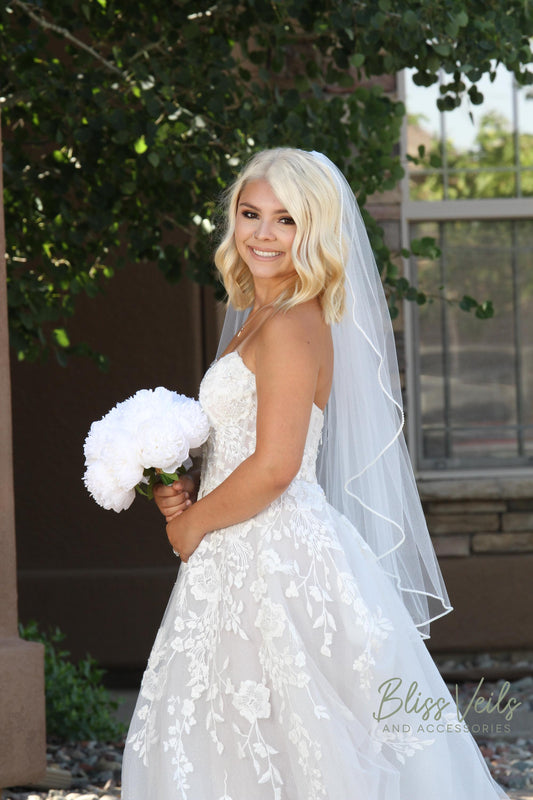 Cascade style wedding veil with pearl trim and soft drape